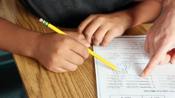 Child working on reading exercises with a specialist